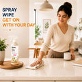 Woman wiping a kitchen counter after using Klevay multi-purpose cleaner: spray, wipe, get on with your day